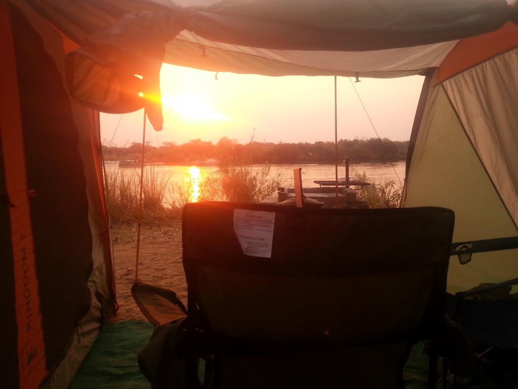 Sunset over the river. Sunsets are really red because of dust/smoke?