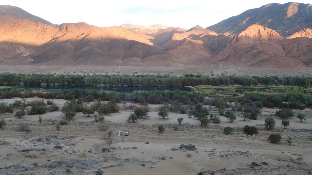 Wild camping next to the Orange River in Namibia at dawn looking across the Orange River to Richtersveld National Park